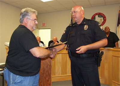 Image: James “J.D.” Doskocil is congratulated by Italy Police Chief Diron Hill on being a member of the first training class of the Citizens Police Academy.