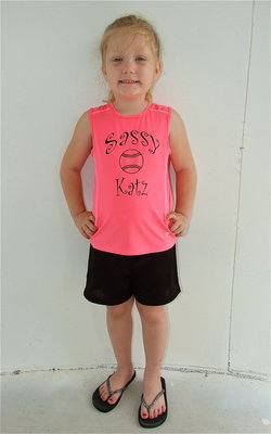 Image: Azlin Itson shows off her Sassy Katz team’s new playoff uniforms. Azlin is very proud of her #6 on the back of her jersey, as well.