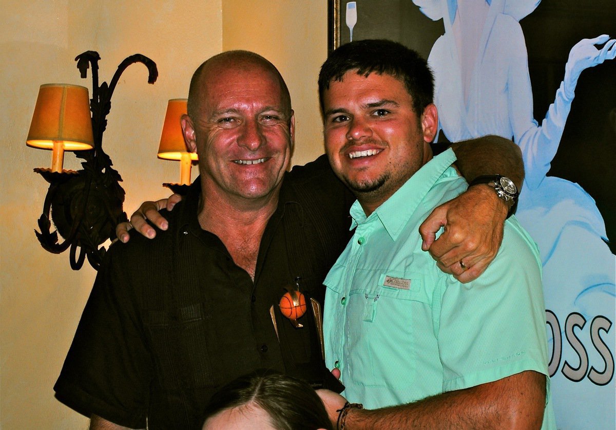 Image: A local Nassau Rotarian presents Andrew Harlow with his Basketball Smiles coaching trophy.