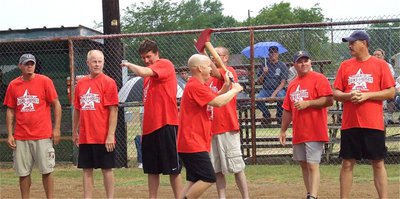 Image: Italy Firefighter Michael Chambers helps get the mojo going as he hustles down the line with the battle axe.