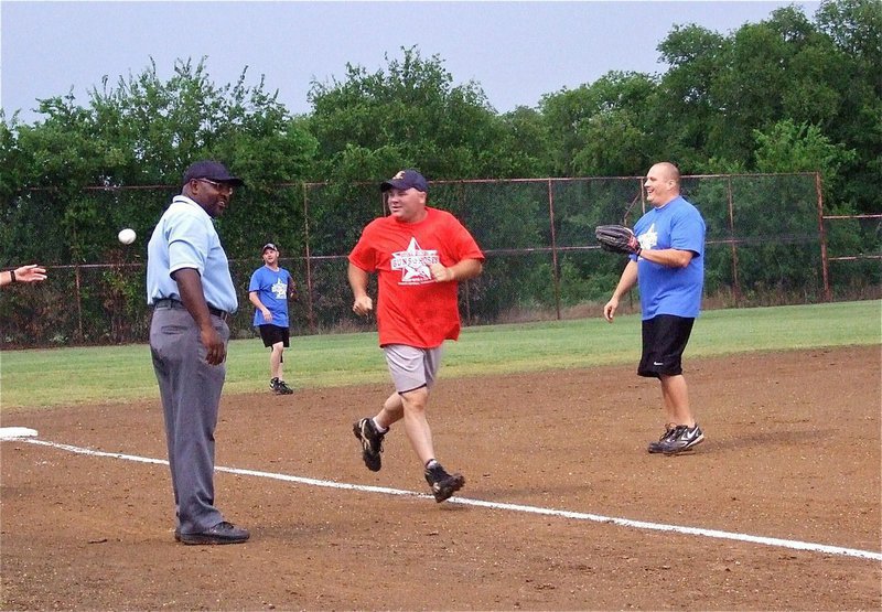 Image: Firefighter Jackie Cate gets the fireworks started early with an over-the-fence home run.