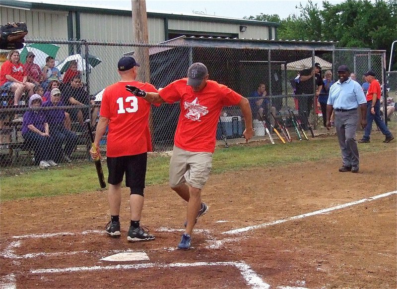 Image: Jeff Evans finishes running the bases after hitting one out of the park for the Italy Fire Department.
