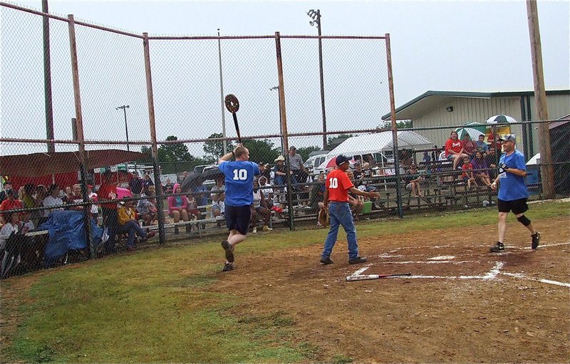 Image: Officer Michael Richardson(10) runs a victory lap with the donut bat held high to celebrate his teammate’s, Officer Shawn Martin, out-of-the-park home run.
