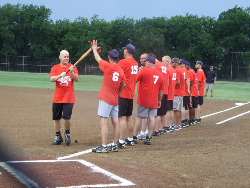 Image: Michael Chambers runs the spirit stick pick-axe by the team for good luck.