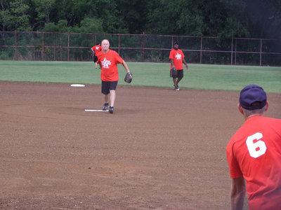 Image: Earl Buchanan pitches the first pitch.