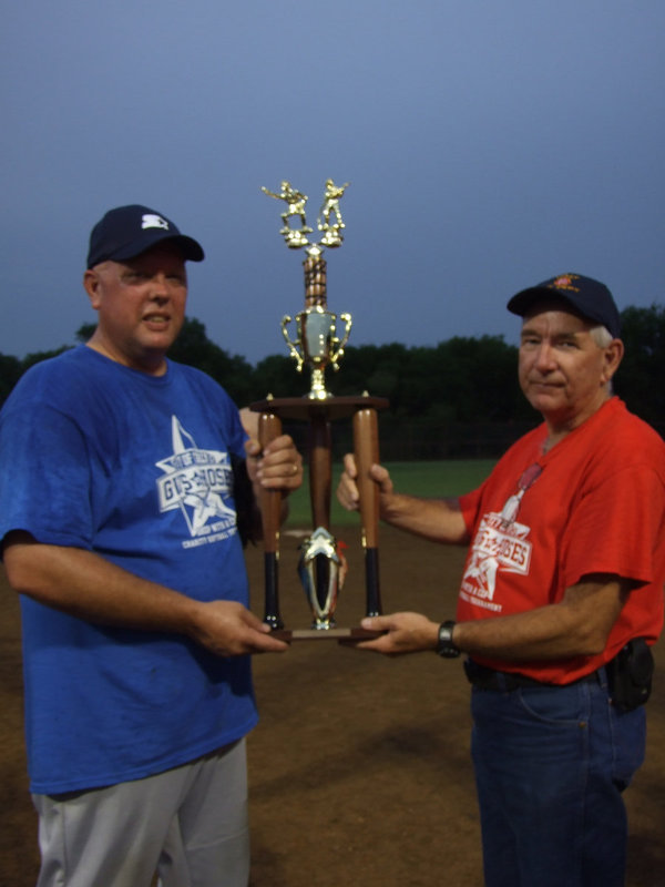 Image: Police Chief Diron Hill and Fire Chief Donald Chambers hold the trophy.