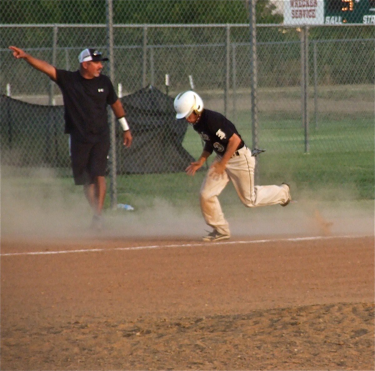 Image: Third base coach Mark Jacinto waves nephew Caden Jacinto home for an Italy run.
