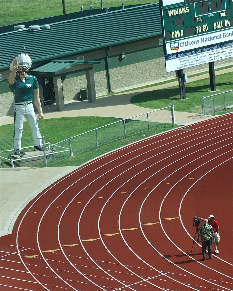 Image: From the press box, you can see Dale Hansen filming the commercial intro as cheerleaders and mascots make their way down to the field.