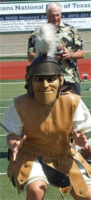Image: Italy Lady Gladiator mascot Reagan Adams protects her quarterback, Dale Hansen, from cheap camera shots.