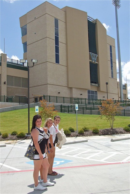 Image: Italy’s Bailey DeBorde, Britney Chambers and Reagan Adams are cheerful after representing the gold and white for a television viewing audience.