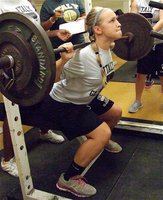 Image: Lady Gladiator Jaclynn Lewis, a sophomore, maxes out along with her volleyball teammates on Midnight Madness Monday.