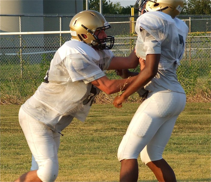 Image: Senior Gladiator Zackery Boykin jars a defender during a drill.