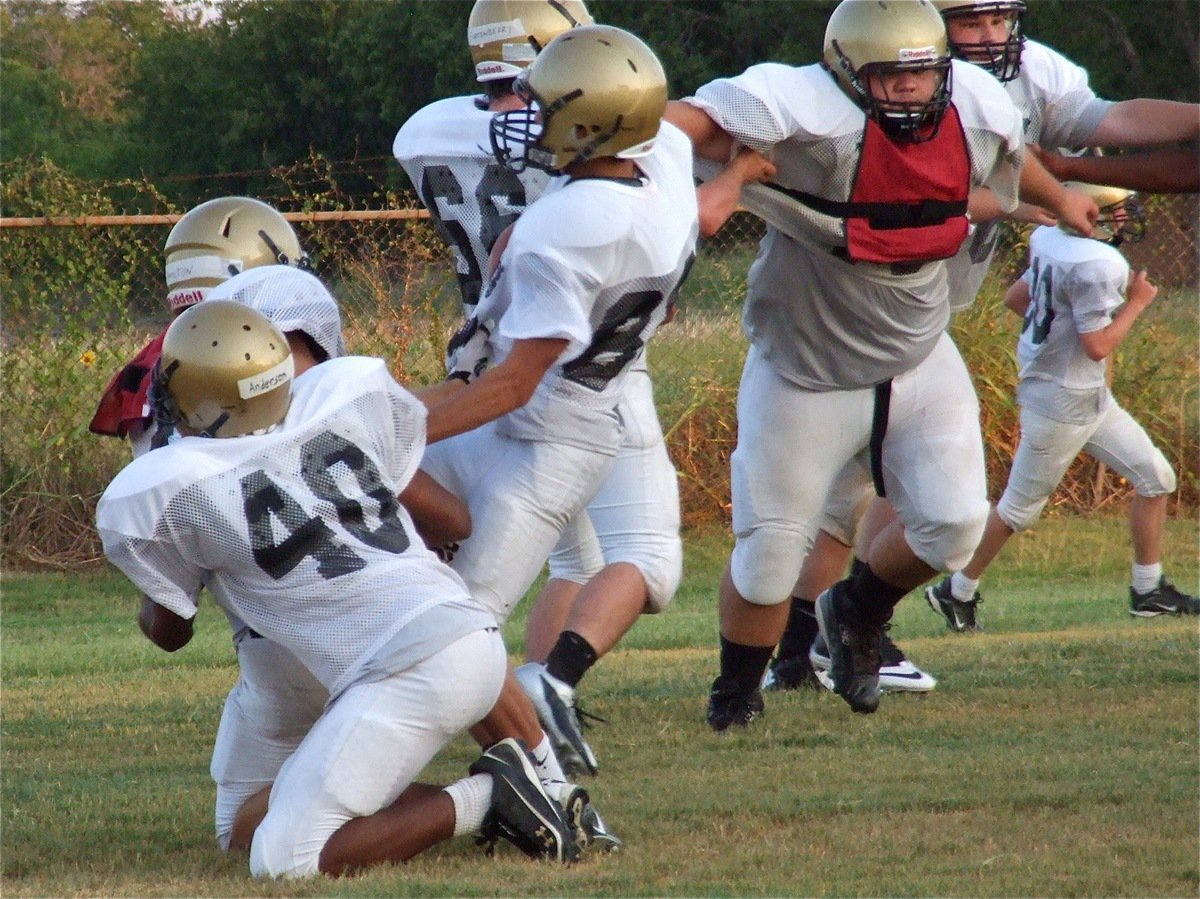 Image: Senior defender Chase Hamilton(2) beats the block to pull down Kelvin Joffre during a team drill.