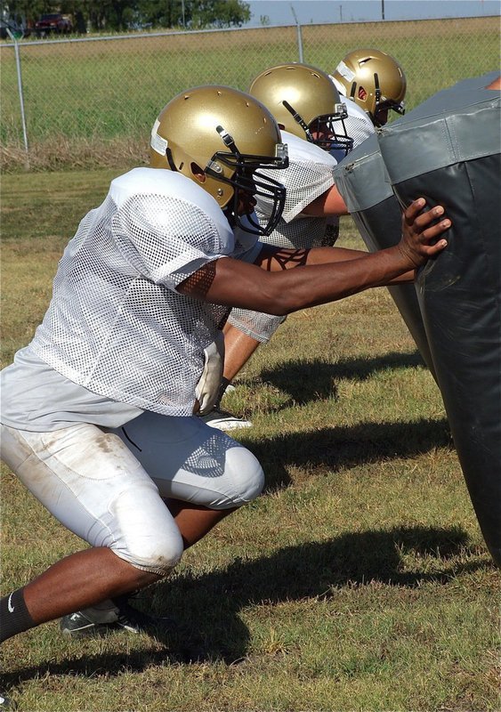 Image: Paul Harris, Hank Seabolt and Zackery Boykin work the sled.