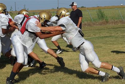 Image: John “Squirt” Hughes tries to hold back Chase Hamilton during a drill.