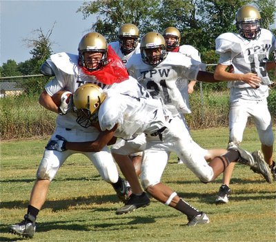 Image: Trevon Robertson(4) puts the hit on pretend Valley Mill runner.