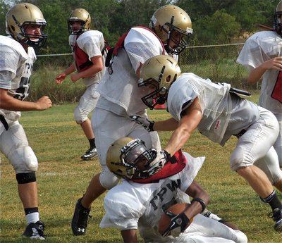 Image: Chase Hamilton(2) tackles everybody despite quarterback Eric Carson’s(5) best efforts to elude the senior hammer.