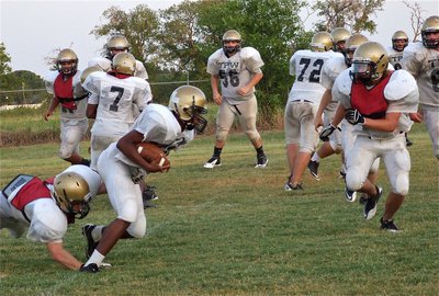 Image: JV back Jaray Anderson(40) fights thru tacklers.