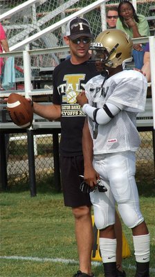 Image: Offensive coordinator Nate Skelton gives one last pointer to quarterback/receiver Eric Carson(5).