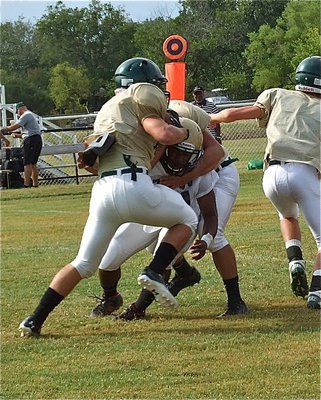 Image: Jalarnce Jamal Lewis(21) fights thru a block and makes the tackle.