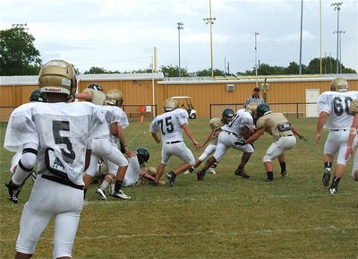 Image: Jalarnce Jamal Lewis(21) breaks tackles on his way to a long run.