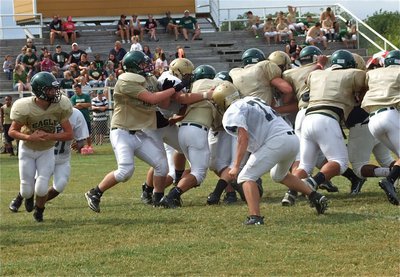 Image: Zain Byers finds the green helmet carrying the ball behind the Valley Mills wedge.