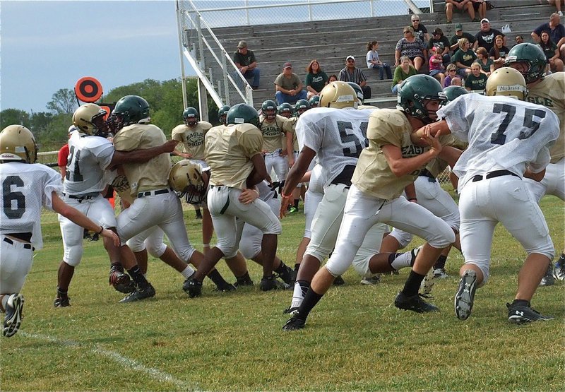 Image: Jalarnce Jamal Lewis(21) forces the runner inside where Zain Byers(50) drops him to the ground during Italy’s 2-0 scrimmage win over Valley Mills.