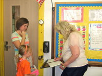 Image: Mrs Nelson getting her students all signed in.