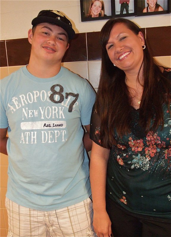 Image: Zain Byers talks math with his Geometry teacher Casey Holden. Mrs. Holden told Zain he was one of her top math students. Zain found out later there was just four kids in his class.