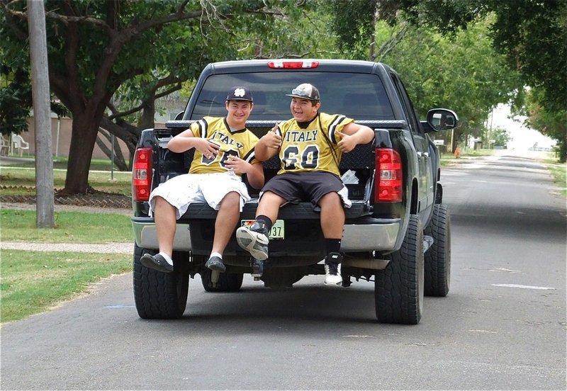 Image: Italy Gladiators Zain Byers(50), Kevin Roldan(60) and driver Cody Medrano(75) go door to door as a part of their team’s Blitz sales campaign to sell restaurant coupons as a fundraiser for the IHS athletic program.