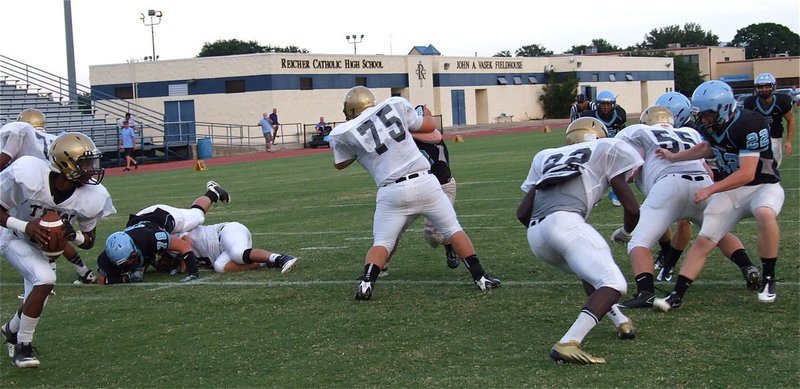Image: Eric Carson(7) rolls out behind his blockers.