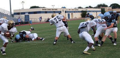 Image: Eric Carson(7) rolls out behind his blockers.