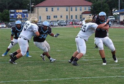 Image: Italy’s offensive linemen Kevin Roldan(75) and Zain Byers(55) maintain their blocks.