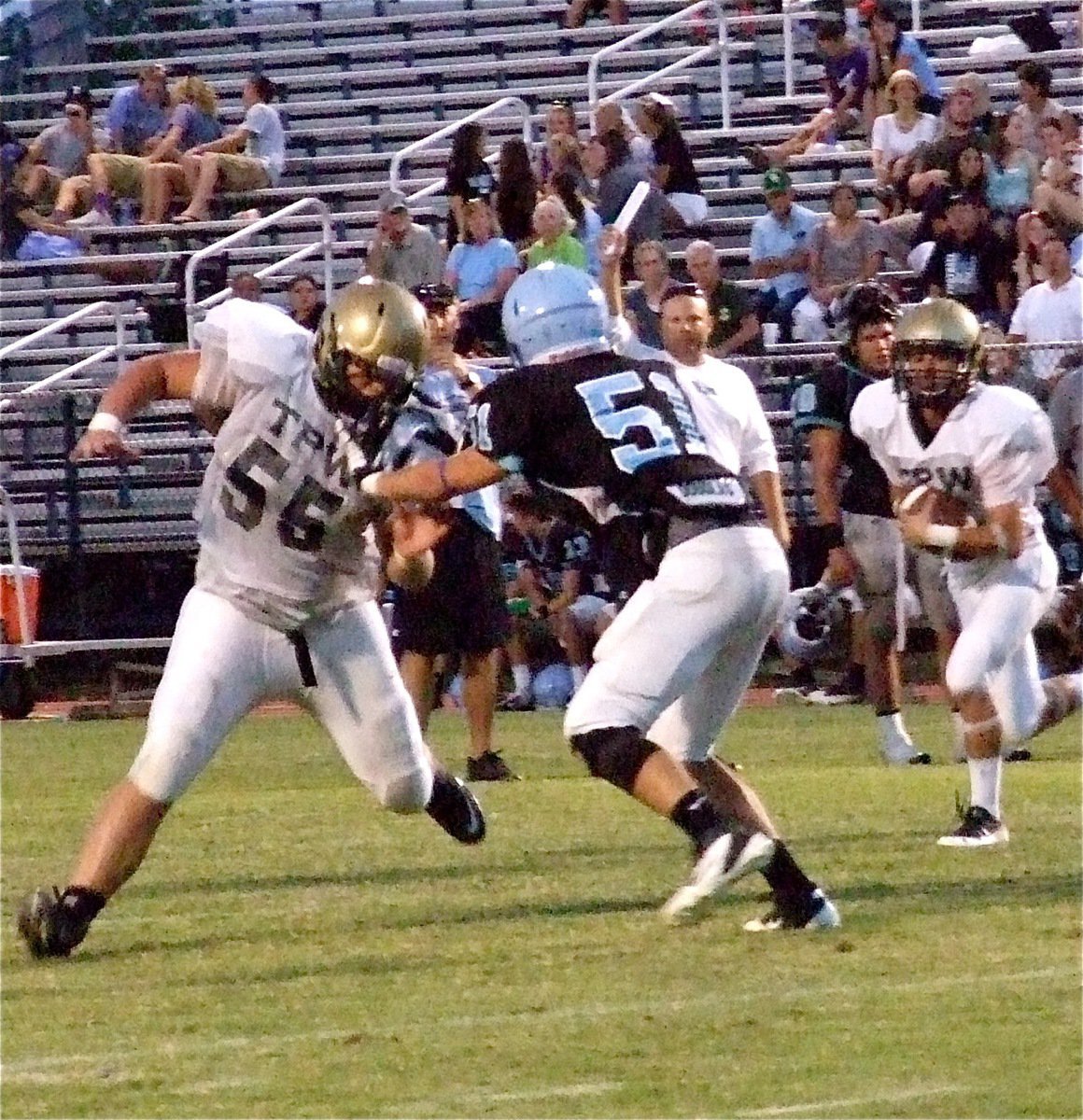 Image: Offensive tackle Zain Byers(55) hooks the Cougar end to make way for Caden Jacinto(5) who gains positive yards.