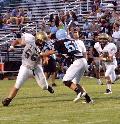 Image: Offensive tackle Zain Byers(55) hooks the Cougar end to make way for Caden Jacinto(5) who gains positive yards.