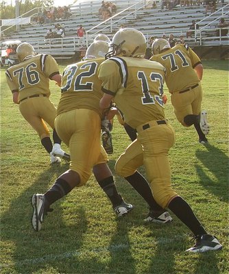 Image: JV quarterback Ryan Connor(13) helps his offense polish their offensive plays before the game.