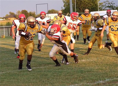 Image: The wheels on the bus go round and round: Billy “Da Bus” Moore goes the distance for a touchdown.