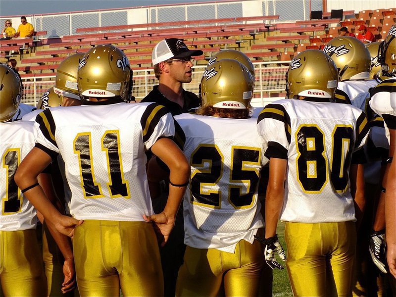 Image: Gladiator offensive coordinator Nate Skelton talks with his players before the game.