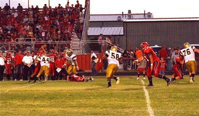 Image: Italy’s Justin Wood(44) reaches Maypearl’s quarterback to force an incomplete pass with help from Cody Medrano(75).