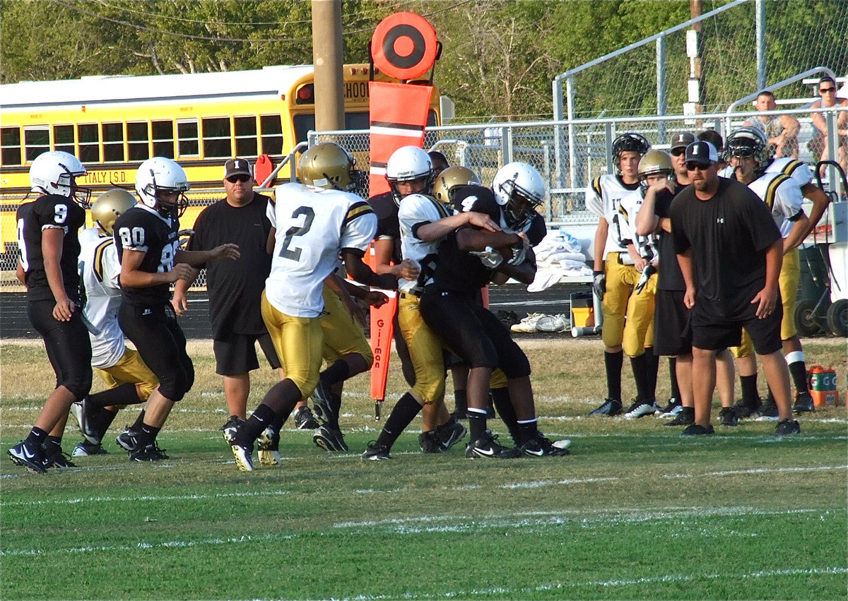 Image: Italy’s John Escamilla(63) clamps down on a Tiger ball carrier.