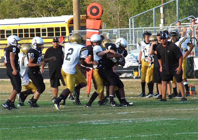 Image: Italy’s John Escamilla(63) clamps down on a Tiger ball carrier.