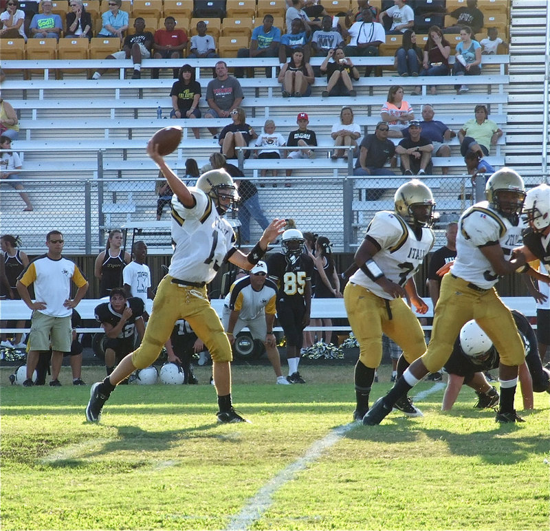 Image: At quarterback, Italy’s Ryan Connor(13) stands tall behind his blockers Billy Moore(32) and John Hughes(50).