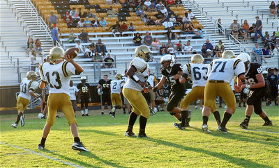 Image: Ryan Connor(13) passes to teammate Levi McBride(10) with Billy Moore(32), Colin Newman(71) and John Escamilla(63) keeping Connor protected.