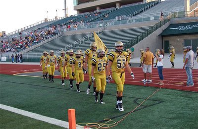 Image: Senior Gladiator Zackery Boykin(55) leads his team into battle against the Malakoff Tigers at Stuart B. Lumpkins Field in Waxahachie.