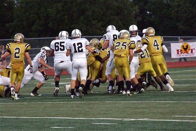 Image: Italy’s defense began the contest with a determined effort as Jalarnce Lewis(21), Reid Jacinto(11), Justin Wood(44) and Eric Carson(12) bring down a Tiger back.