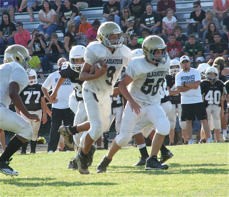 Image: Elliott Worsham(56) leads the way for Devonteh Williams(9).