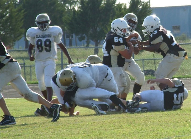 Image: Aaron Pittmon(50) tackles a Hubbard ball carrier.