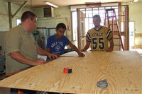 Image: IHS Ag Teacher Blake Godwin oversees the construction of a visitor side concession stand for the football field.