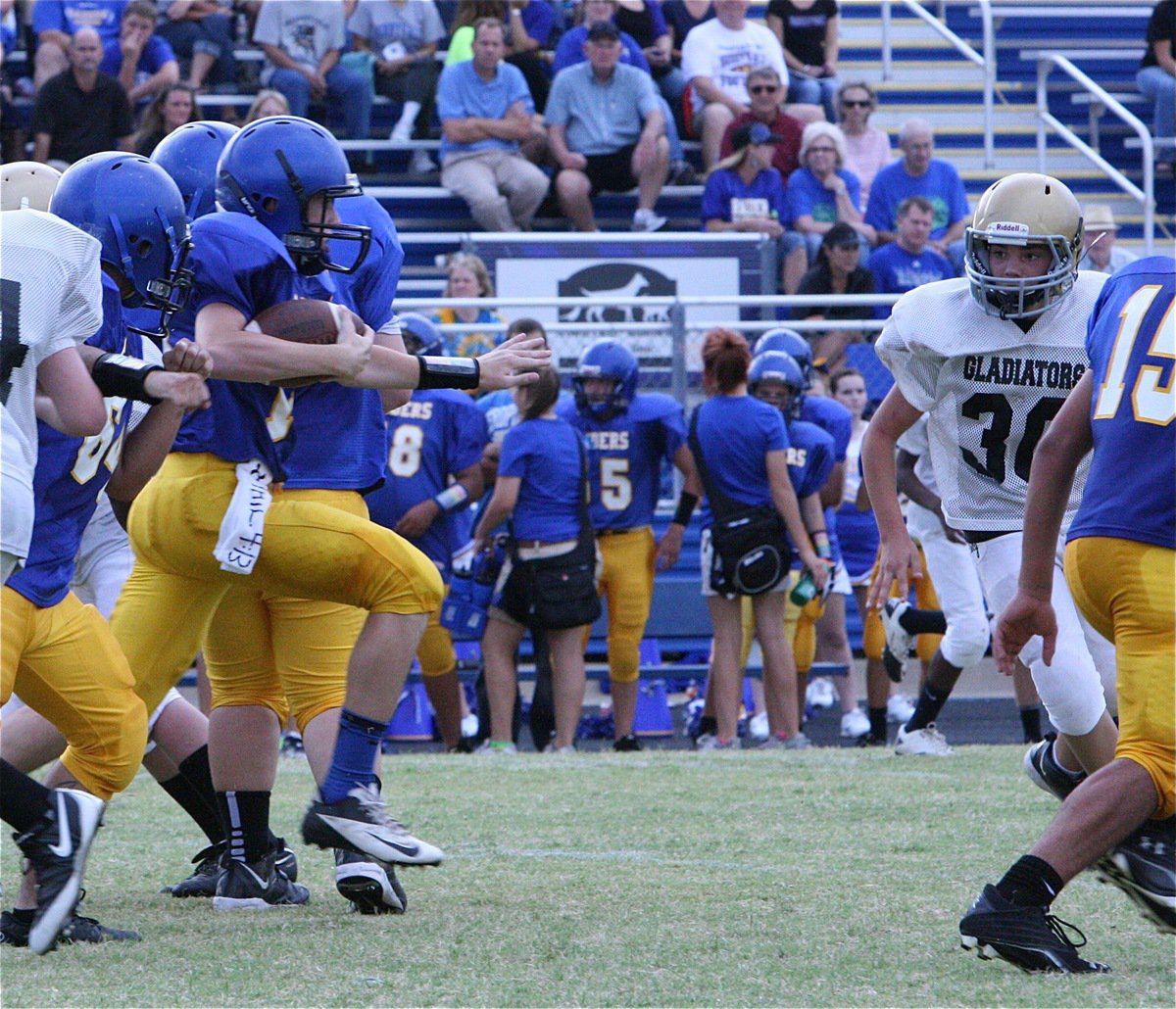 Image: 8th grader Gladiator Blake Brewer(30) zeroes in on a Sunnyvale runner.