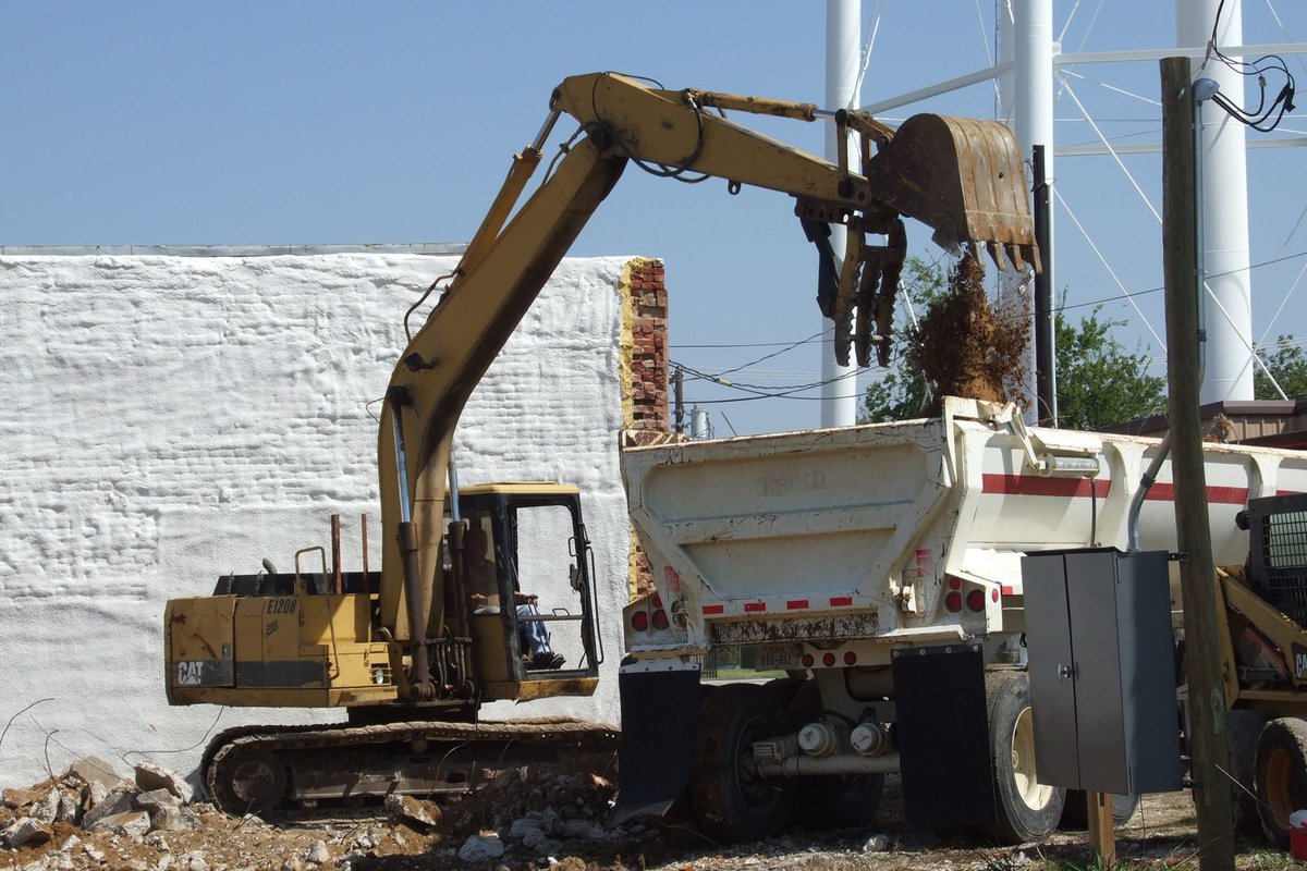 Image: Debris is loaded into trucks for transport.